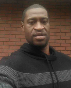 Selfie of Floyd wearing a black and gray hoodie