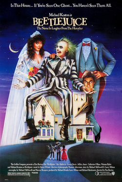 A woman in a wedding dress, a green haired white faced man in a striped suit, and on their right, a headless man whose head is being held by the green-haired man.