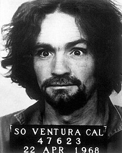 Manson holds a sign which reads "SO VENTURA CAL - 47623 - 22 APR 1968" for his mug shot