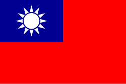 A red flag, with a small blue rectangle in the top left hand corner on which sits a white sun composed of a circle surrounded by 12 rays