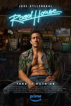 Jake Gylenhaal's Elwood Dalton sits with bruises, cuts, and an unbuttoned shirt in the middle of a roadhouse.