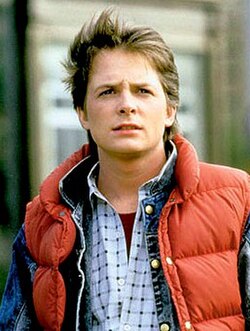 Marty McFly wearing a red vest over a checkered shirt