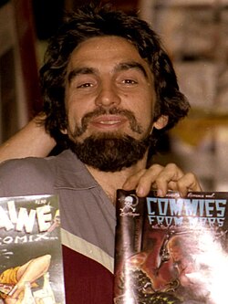 George DiCaprio and Ron Turner holding up comic books including Commies from Mars and Cherry Poptart