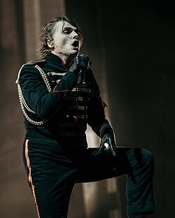 Gerard Way performing live on stage.