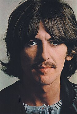 Harrison with shoulder-length hair and a moustache