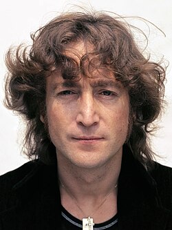 A colour photograph of John Lennon in his mid-thirties